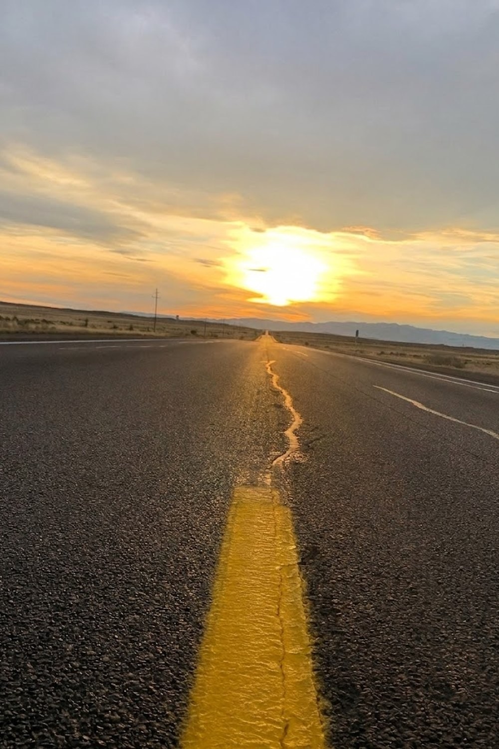 Entering Adulthood, cover photograph by Keith Emory: a two-lane road at sunset.